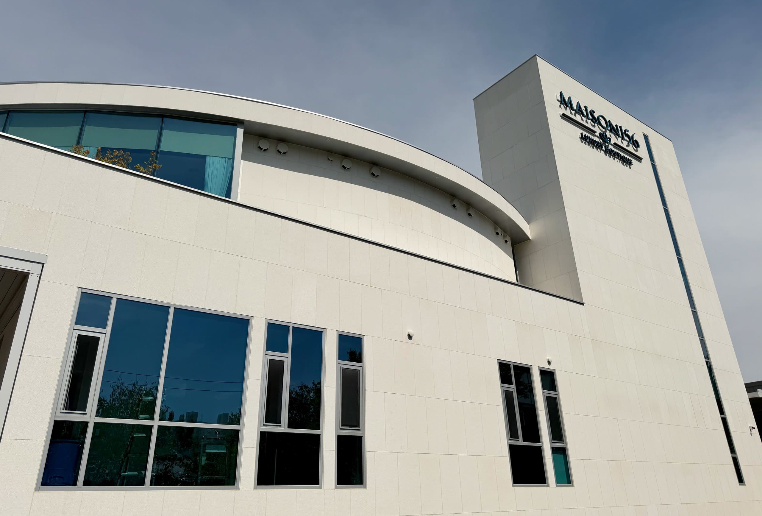 The white stone facade and MAISON 156 signage