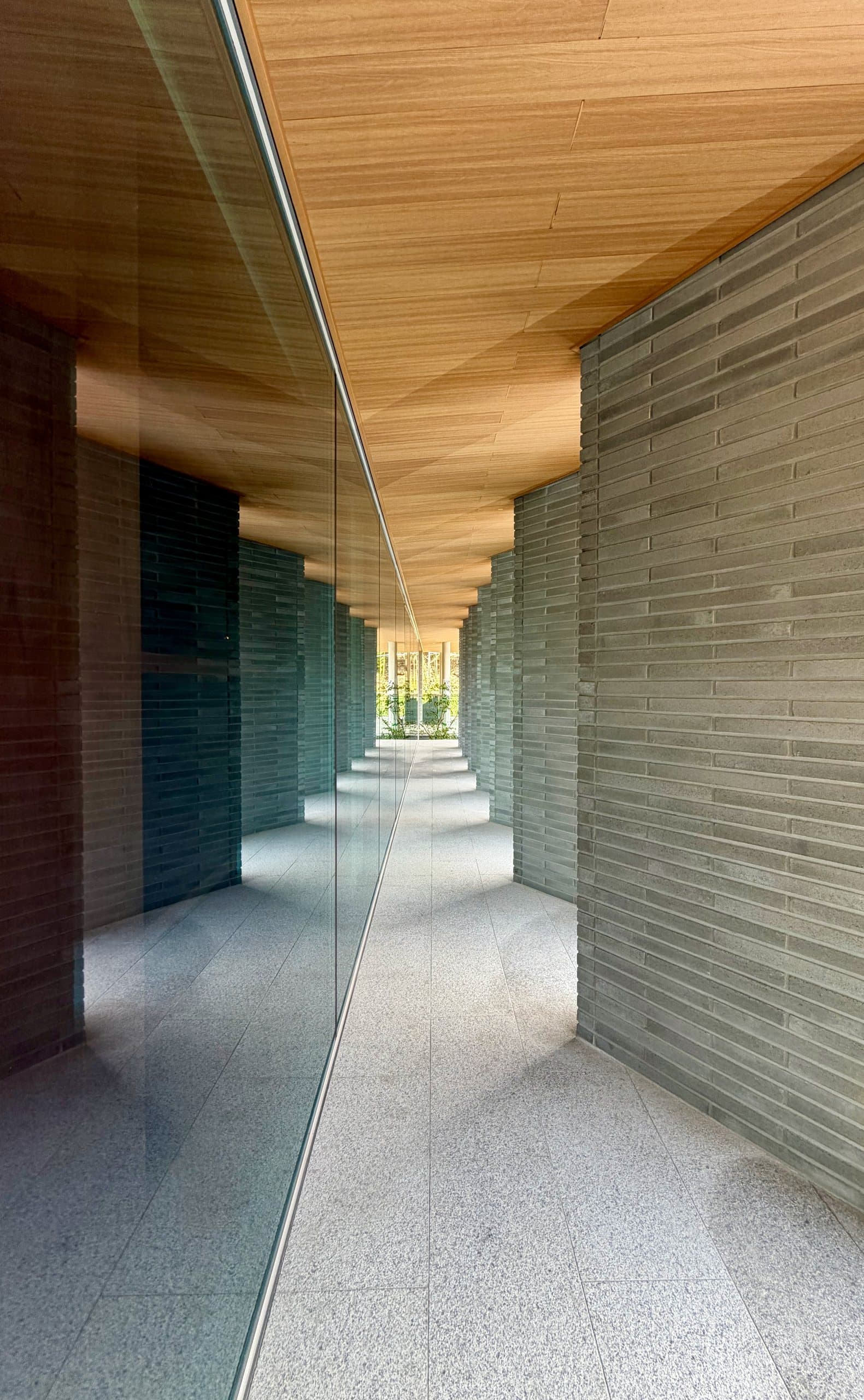 The brick colonnade beneath a timber ceiling