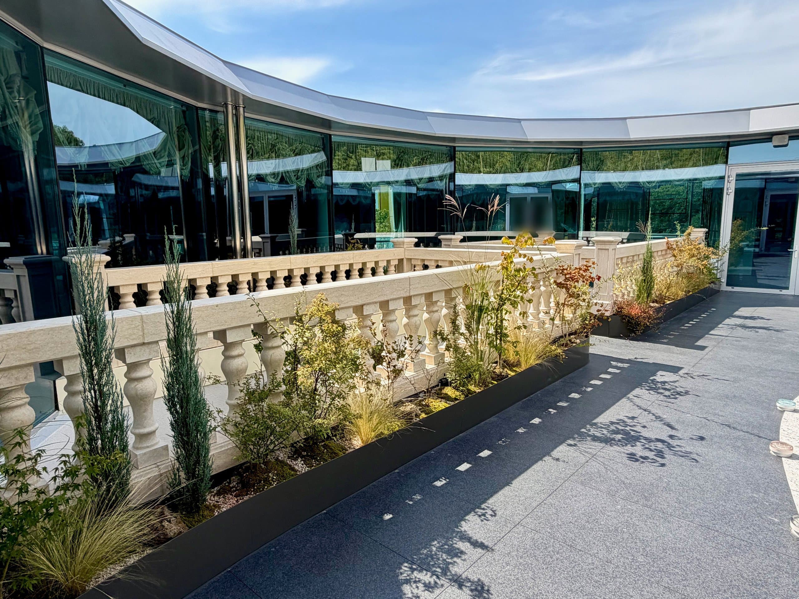 The planted terrace and stone balustrades of the pavilion